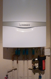 A boiler replacement installation with a Vaillant ecoTEC combination boiler and a Magnaclean filter installed